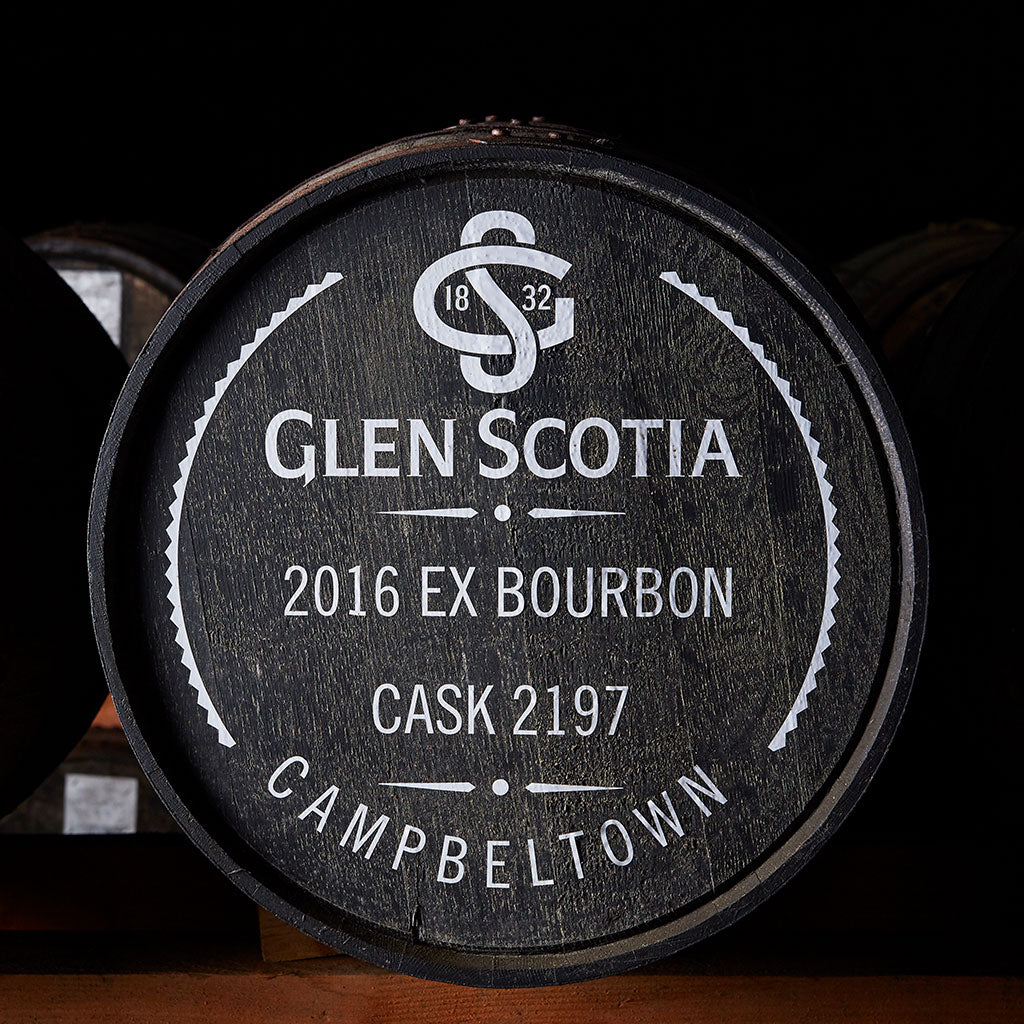 A close-up of a wooden barrel with white text. The text reads, "Glen Scotia, 2016 Ex Bourbon, Cask 2197, Campbeltown," with "SG 1832" in a logo at the top. The barrel is against a dark background.