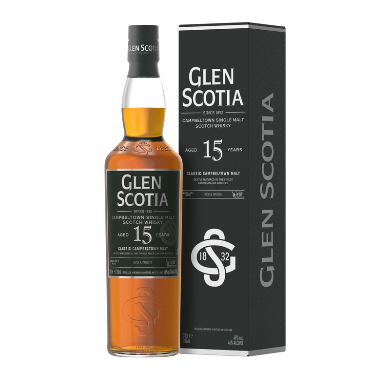 A bottle of Glen Scotia 15 Year Old Single Malt Scotch Whisky, aged in bourbon casks, is displayed next to its dark green box. The bottle features a black label with silver text that highlights its age and origin, while the box mirrors the design of the bottle’s label.